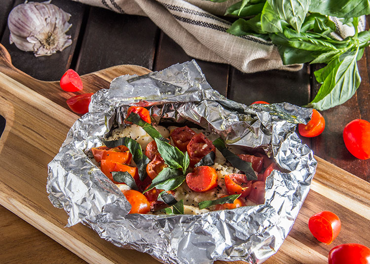 Tilapia and veggies in foil packet